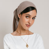 Model wearing 18k gold-plated jewelry featuring a Tennis Necklace layered with a long pendant necklace, paired with Tennis Earrings.