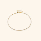 18k gold-plated Tennis Necklace featuring a continuous strand of round clear crystals with an adjustable extension chain.