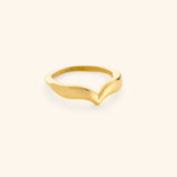 The Keffiyeh Droplet Ring by Nominal, featuring a smooth, polished 18k gold-plated band sculpted into an organic contoured chevron silhouette, displayed on an off-white background.