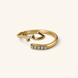18k gold-plated Love Wrap Bezel Ring featuring an open wrap band with Arabic "Hub" (Love) calligraphy on one end and a line of bezel-set clear crystals on the other.