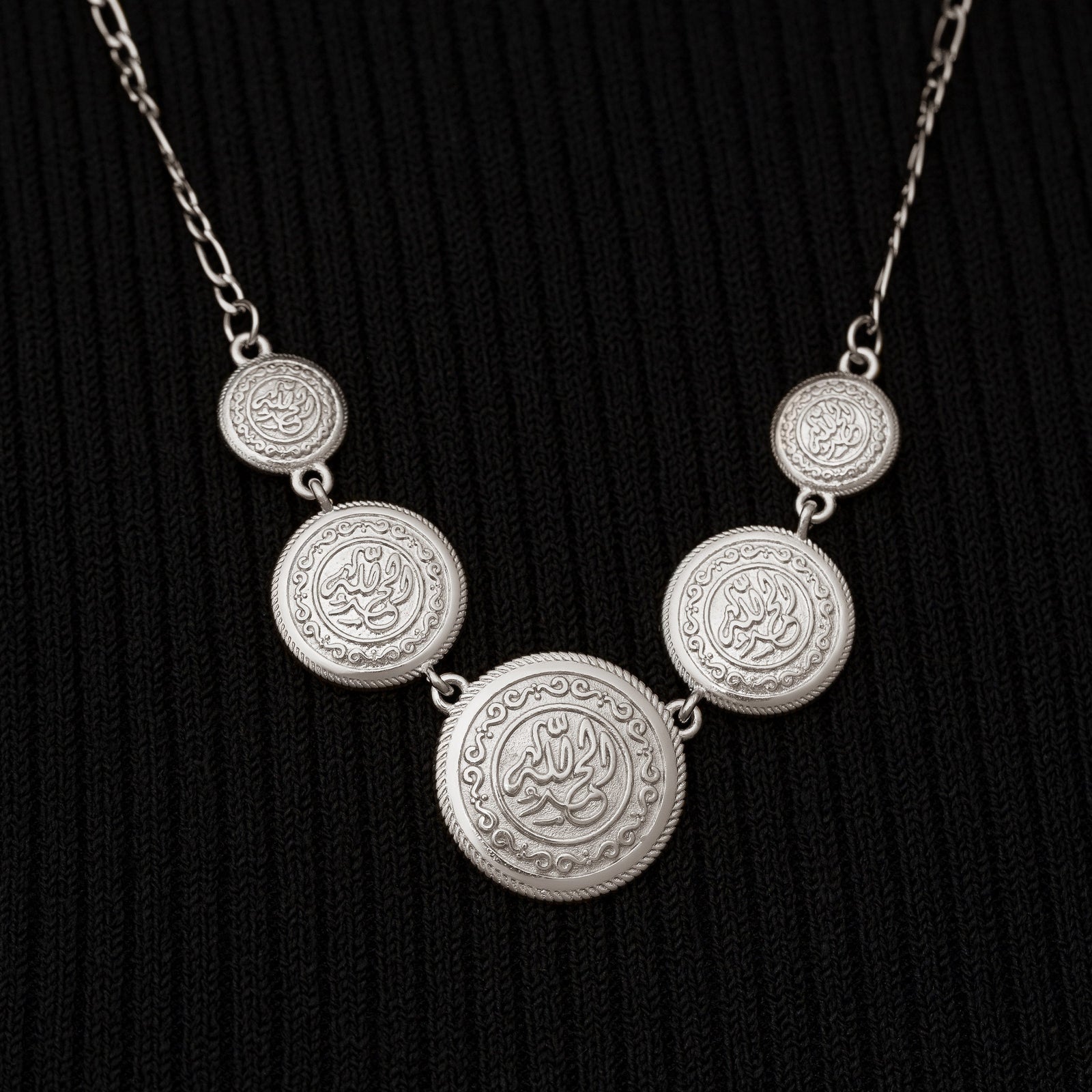 Close up of the silver coins at the center of the silver Alhamdulillah Coin Necklace.