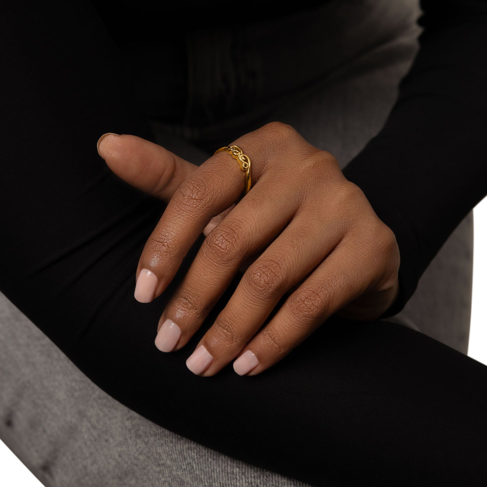 A model wearing the 18K gold-plated Arabic Mama Ring on her finger.