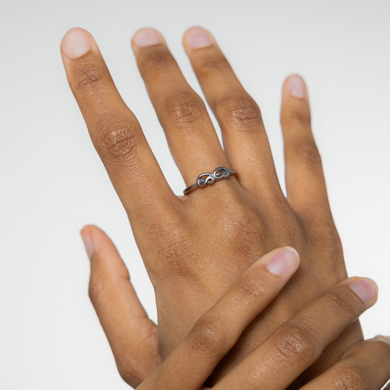 A model showcasing the silver Arabic Mama Ring on her finger.