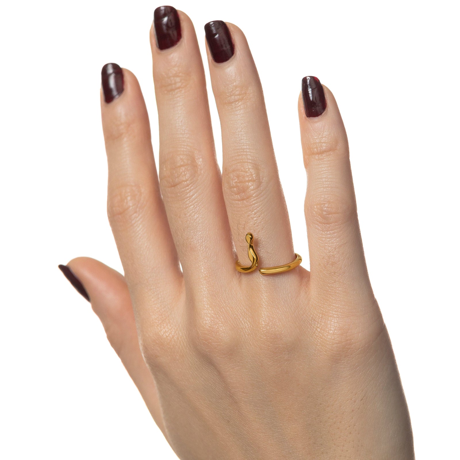 Photo of the model's right hand, gold Arabic Letter Wrap Ring worn on their right ring finger.