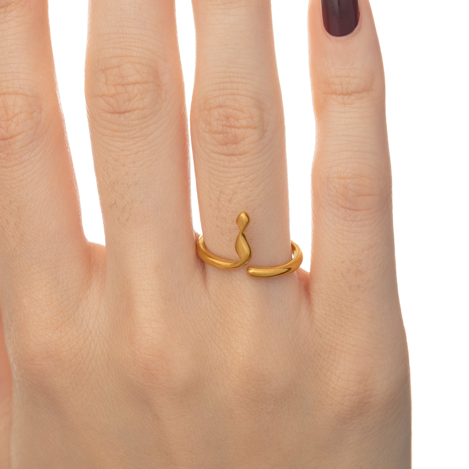 Close up of the Arabic Letter Wrap Ring worn by the model
