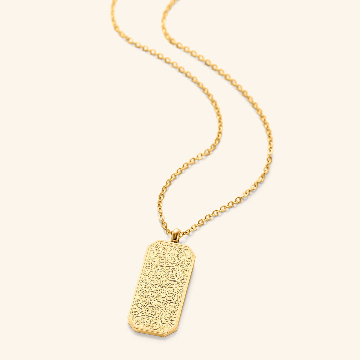 An 18k gold plated necklace Ayatul Kursi engraved on the tag. The pendant is hanging on a thin gold plated chain.