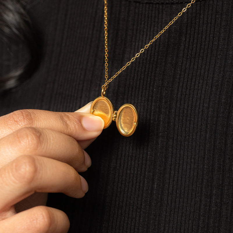 Gold Ayatul Kursi Locket shown open to reveal its interior photo compartments