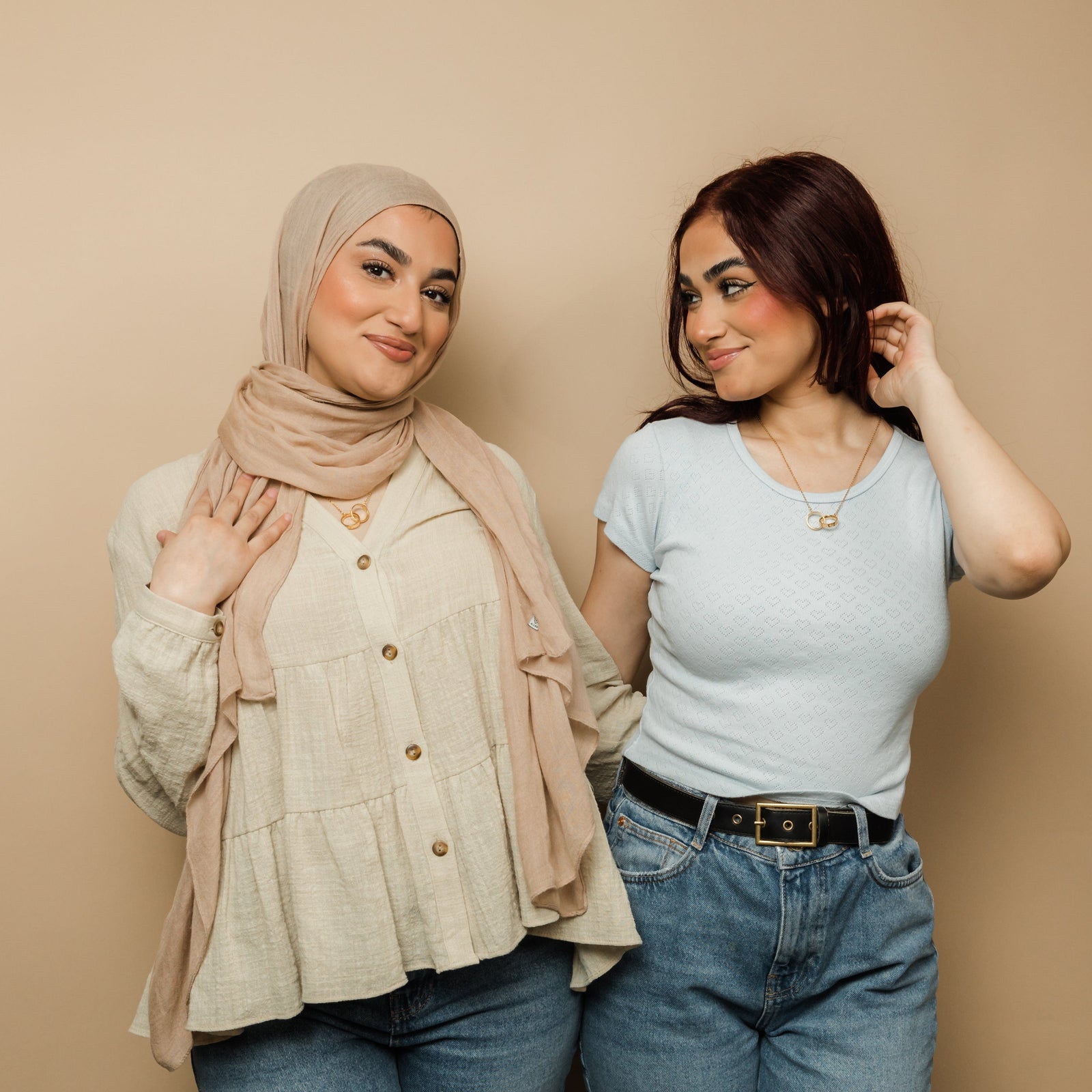 Two models wear one necklace each from the set, with the pendants symbolizing a shared connection and unity in friendship.