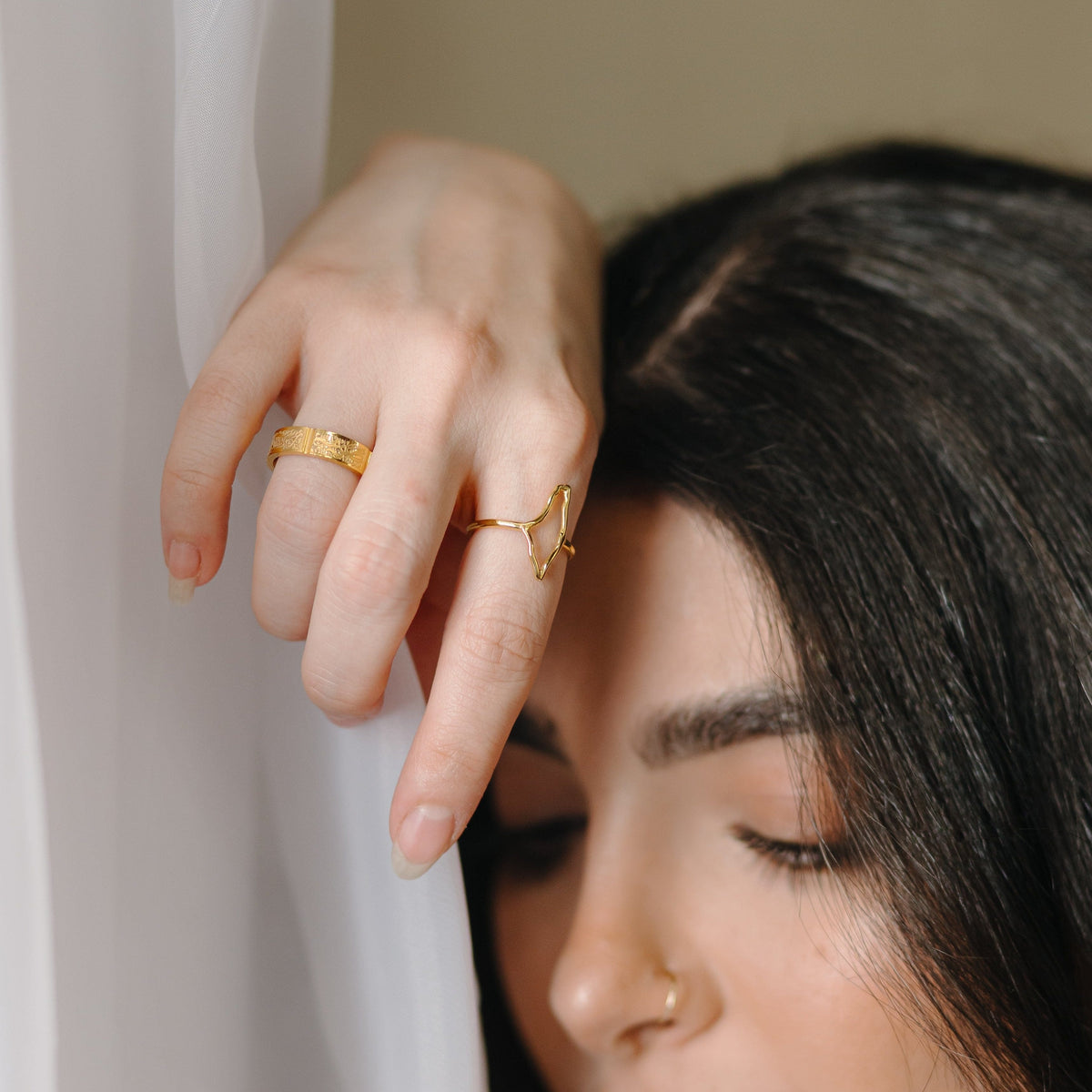 A model wearing the Palestine Ring in gold, with the outline of the map of Palestine sitting prominently atop the finger, forming the main body of the ring.