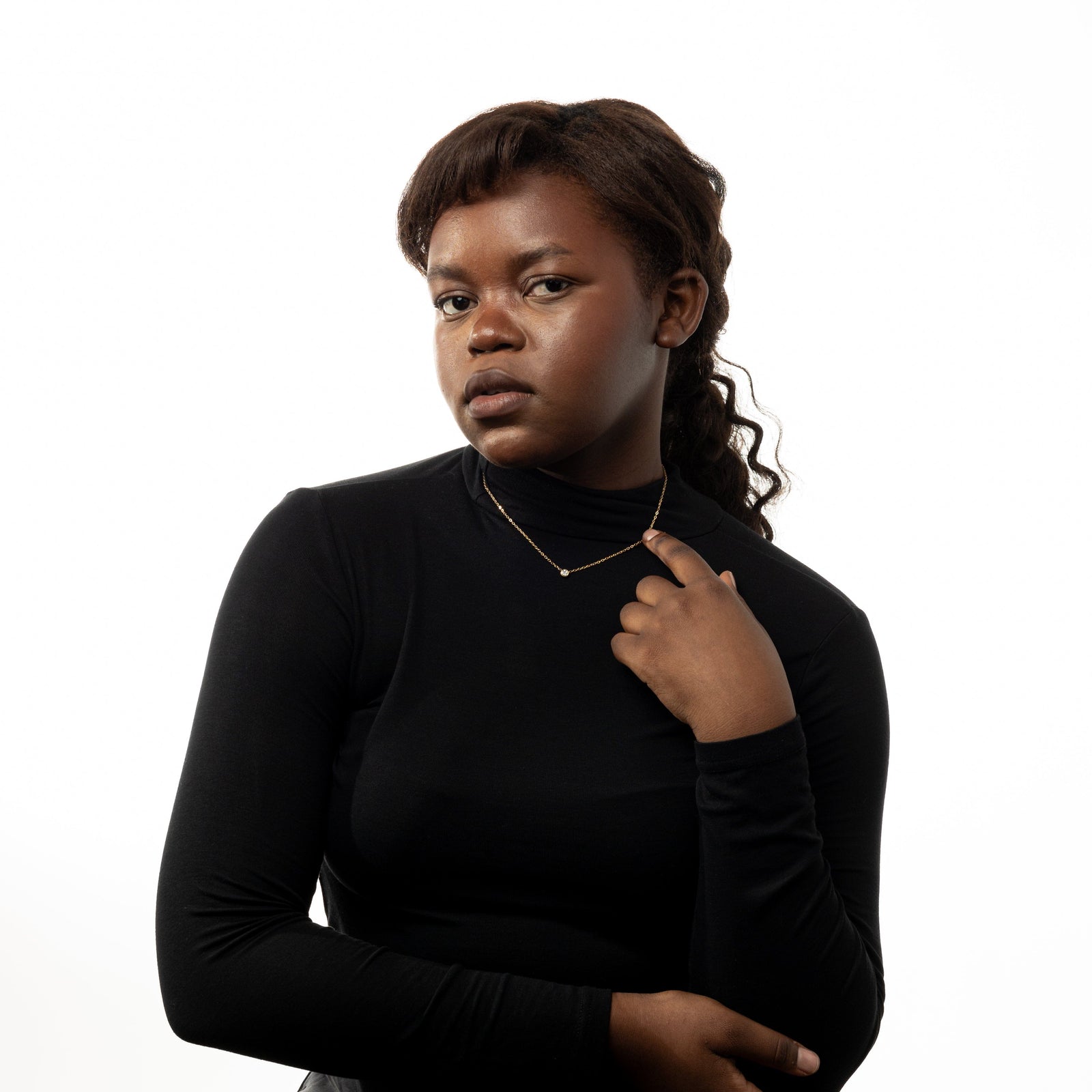 Photo of the model wearing the gold Bezel Necklace.