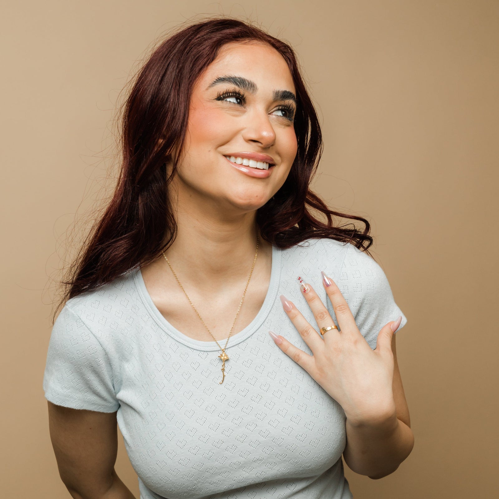 Photo of the model wearing the gold Blooming Love Necklace