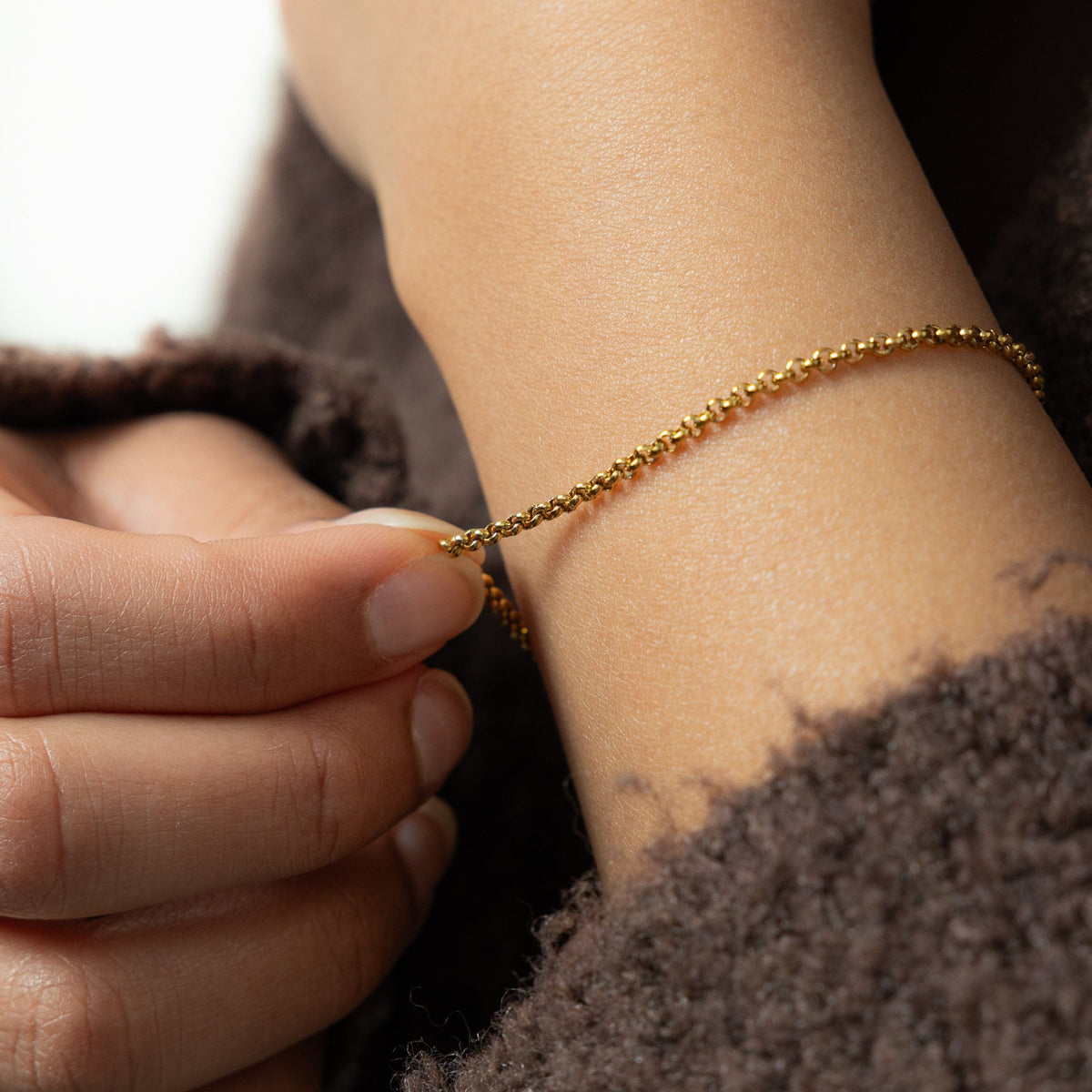 Close up of the gold Micro Box Bracelet as worn by the model