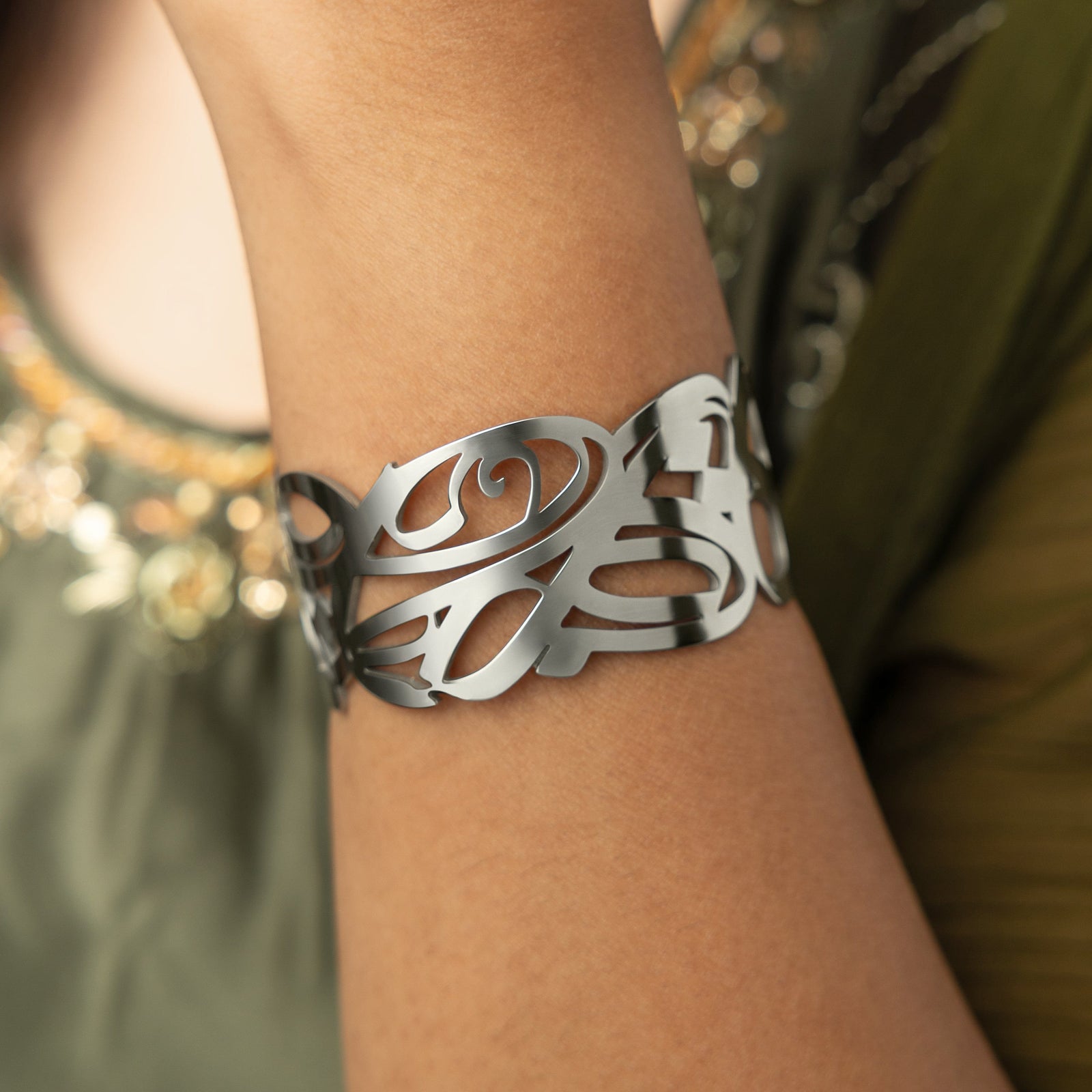 A silver cuff bracelet with intricate, swirling cut-out designs. The bracelet is wide and open-ended, and the delicate patterns create a lacy or filigree effect. The text "GRACE (Cuff) | Aadil x Nominal" indicates this is a product shot of the "Grace" cuff bracelet, a collaboration between Aadil and Nominal.