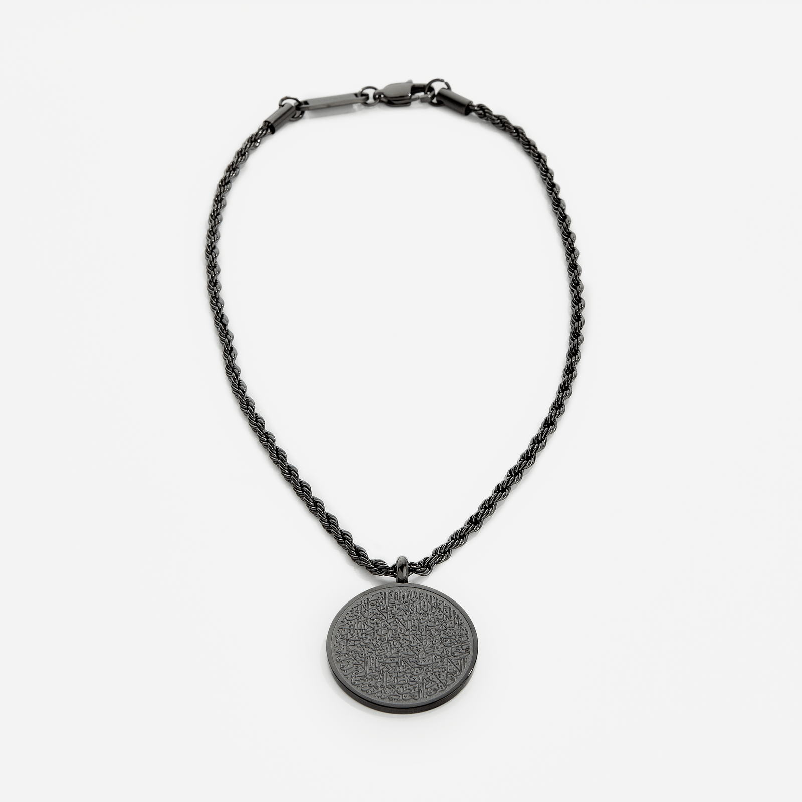 Photo of an black Car Hanger.  A timeless pendant on a classic rope chain, the new Ayatul Kursi Car Hanger uses our classic calligraphy design of the most powerful verse in the Qur'an, now meant to take with you, everywhere you go.