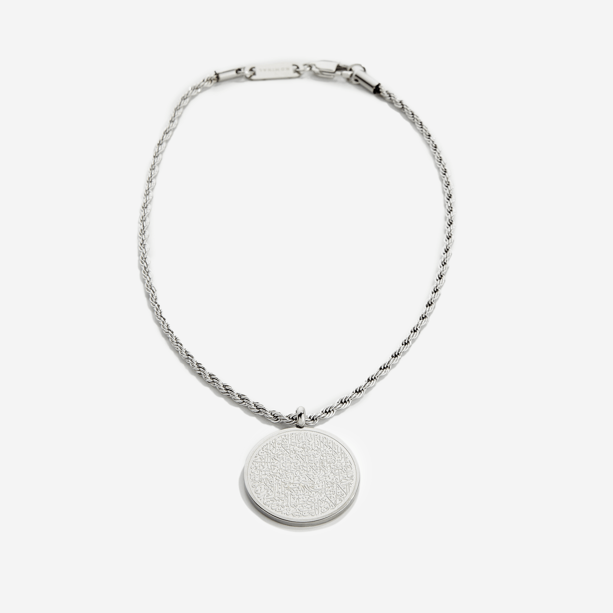Photo of an silver Car Hanger.  A timeless pendant on a classic rope chain, the new Ayatul Kursi Car Hanger uses our classic calligraphy design of the most powerful verse in the Qur'an, now meant to take with you, everywhere you go.