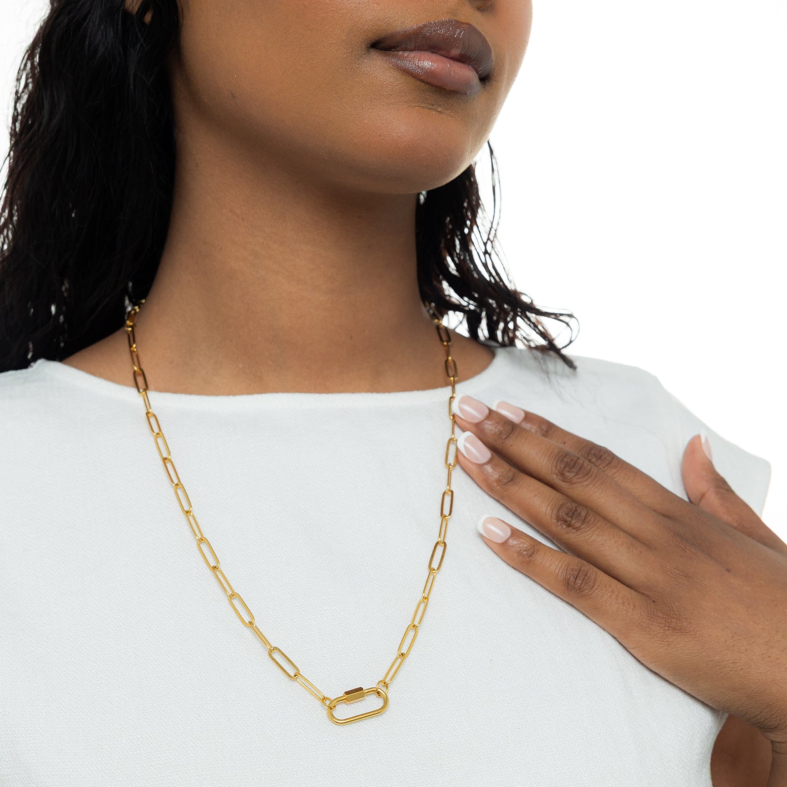 A model wearing the gold-plated Charm Keeper Necklace with a carabiner clasp, showcasing the necklace's design and fit.