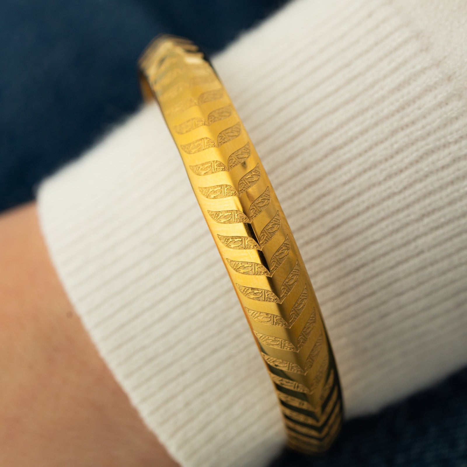 Close up of the gols DIVINE WILL (Bangle) | Aadil x Nominal as worn by the model.