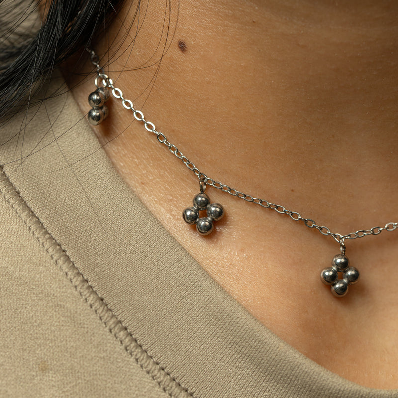 Silver Henna Choker styled at the neckline with bead cluster details visible.