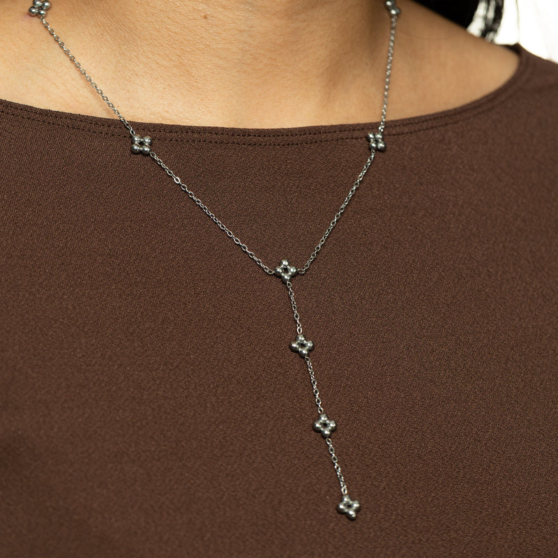 Silver Henna Lariat Necklace styled on neckline against a brown top.