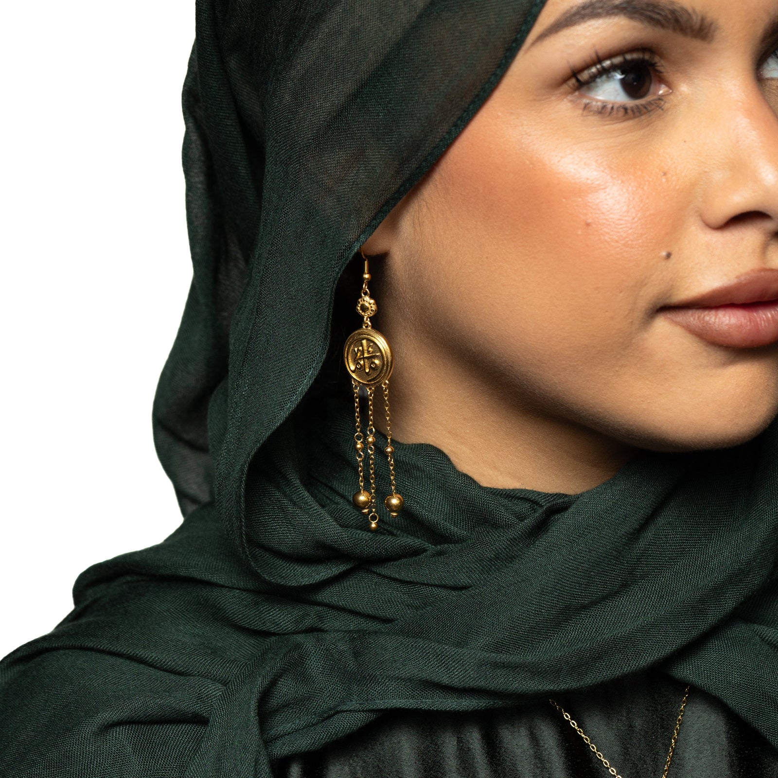Photo of the model wearing the gold Coin Mama Earrings on their right ear.