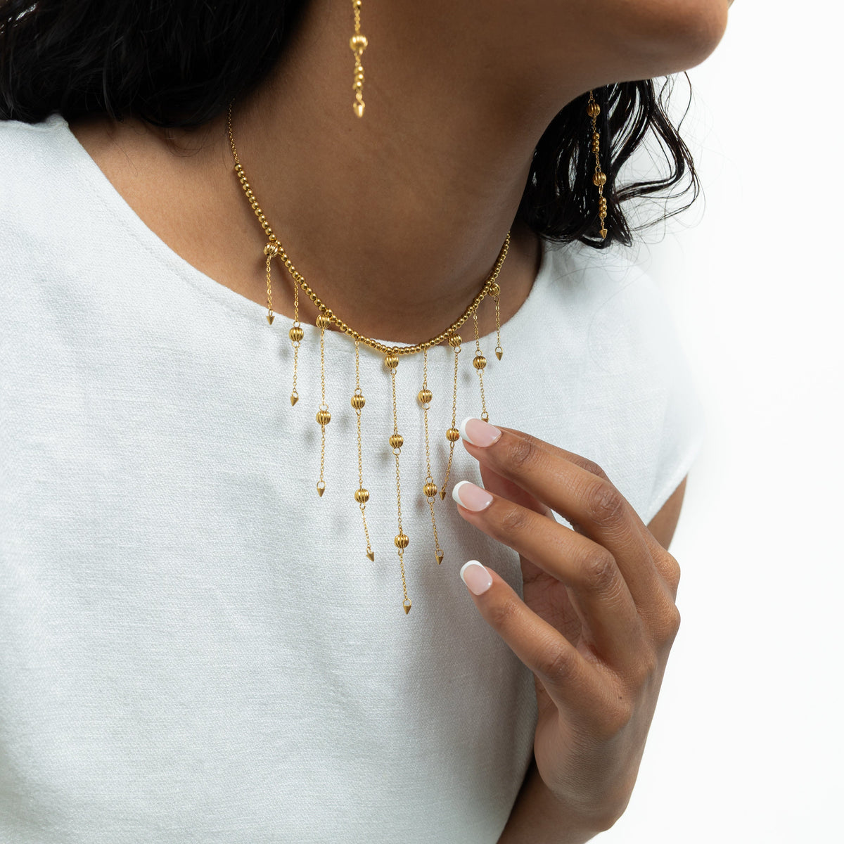 Close up of the gold Comet Choker as worn by the model.