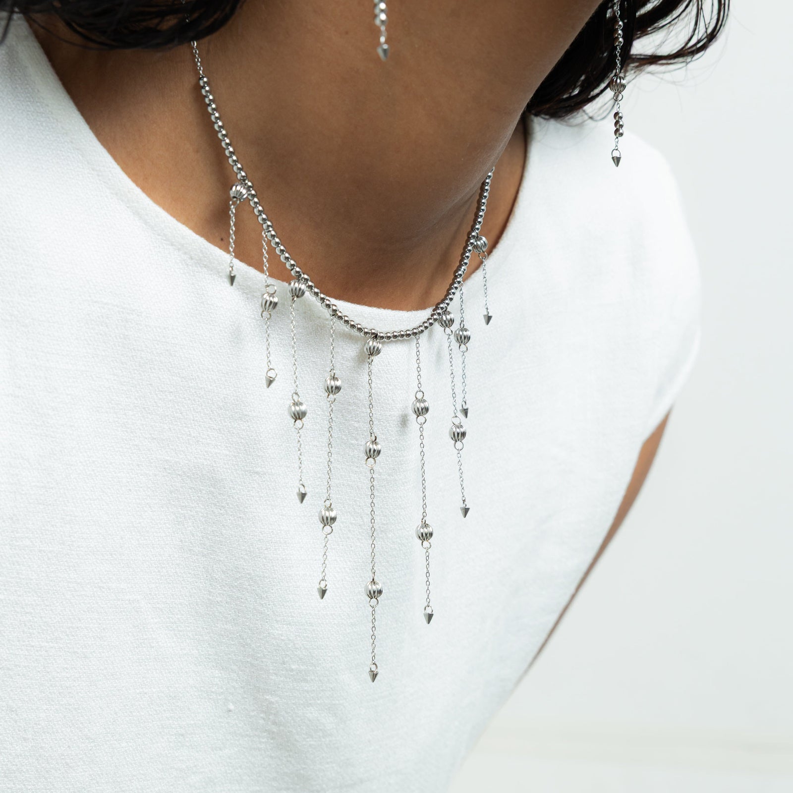 Close up of the silver Comet Choker as worn by the model.