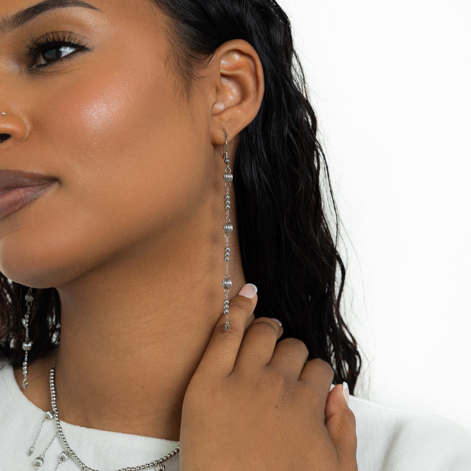 Photo of the model wearing the silver Comet Earrings.