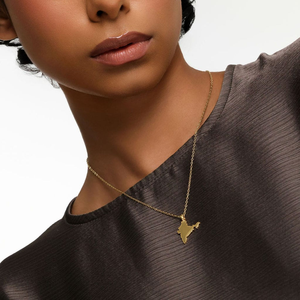 Close up of the model wearing the gold Country Map Necklace | Women.