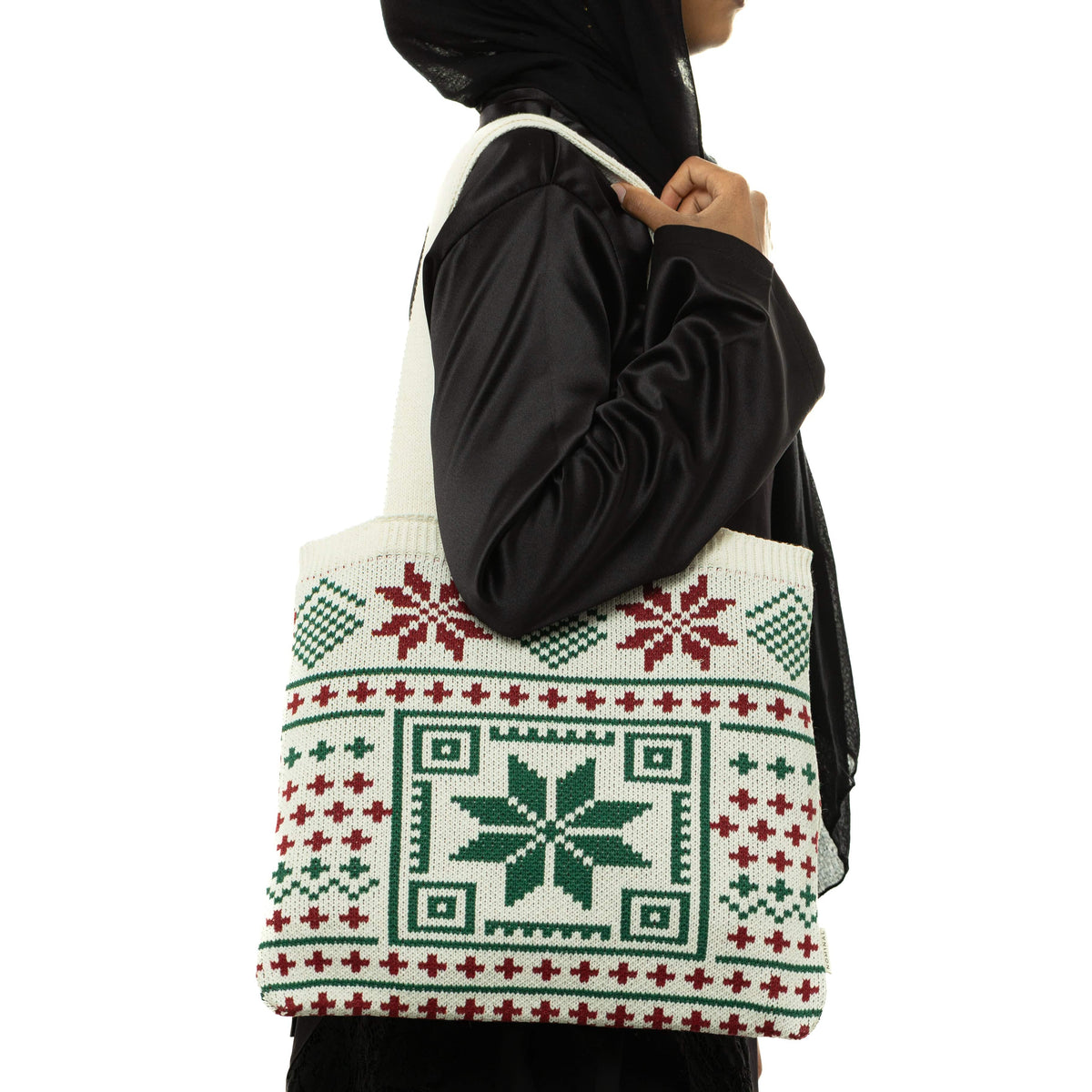 Side profile of the model, showing the Knit Crochet Tatreez Tote they are carrying on their right shoulder.