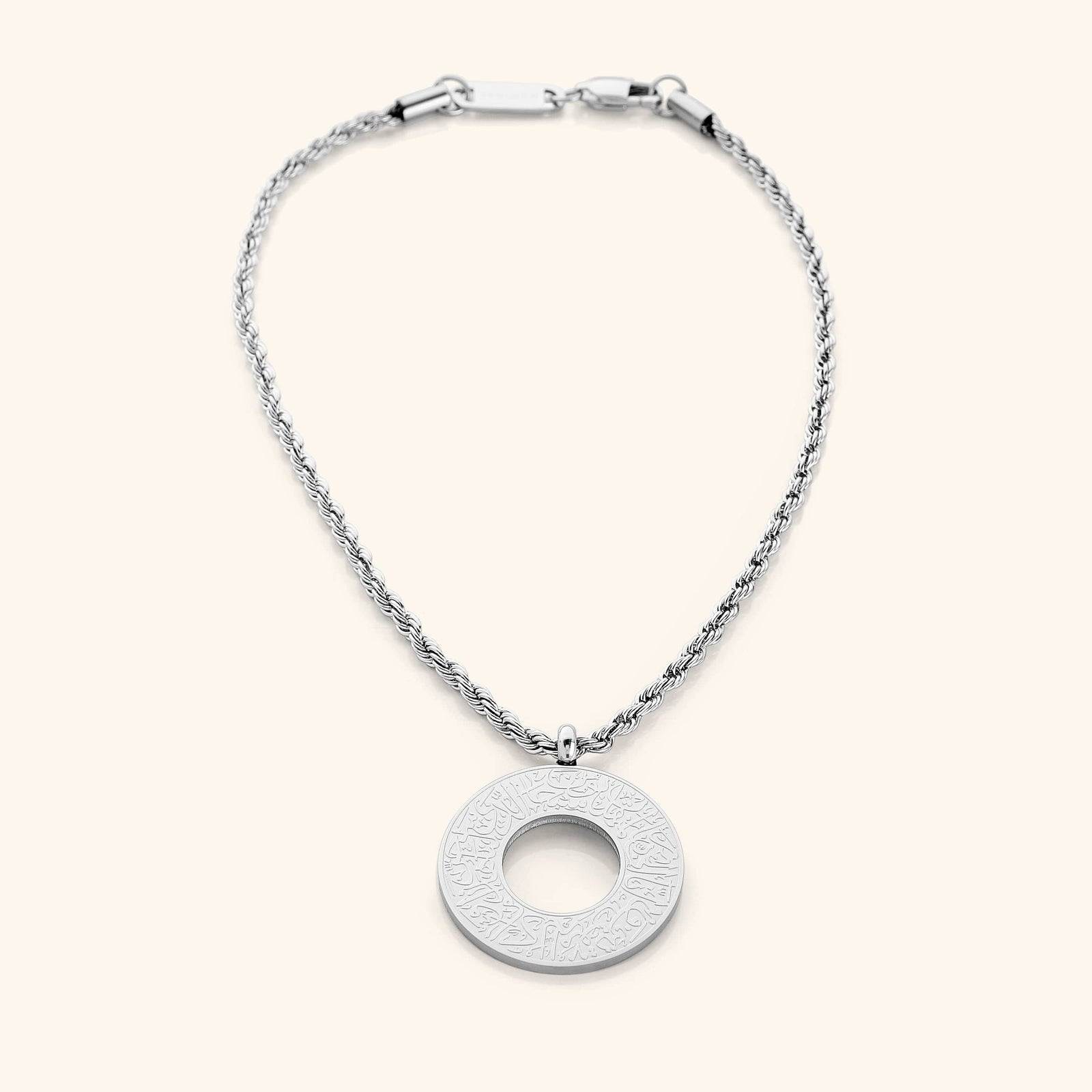 Silver circular car hanger with an open circle center, engraved with Duaa Al-Safar in Arabic calligraphy on a neutral background.