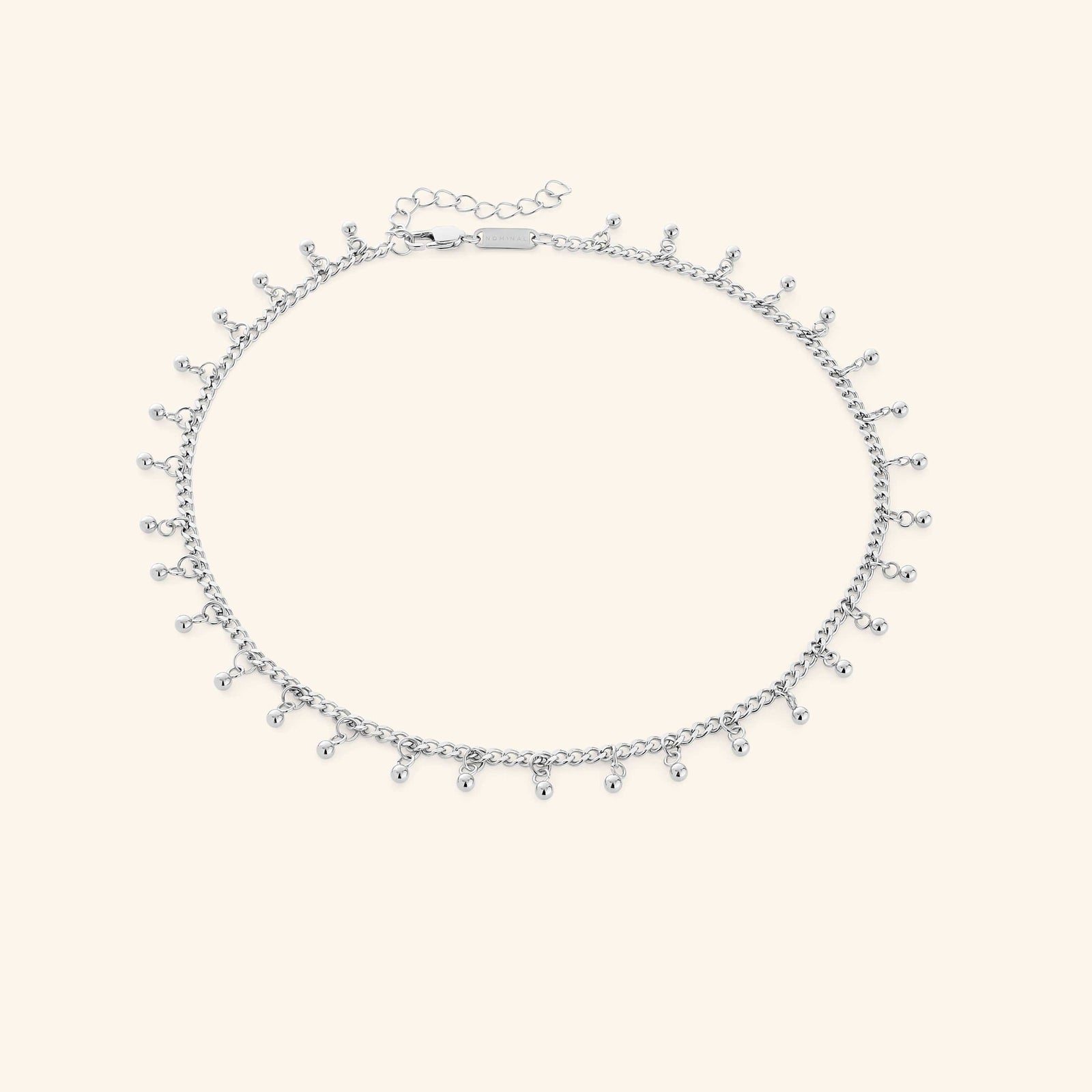 A close-up of the Dangling Dotted Choker in silver. The choker features a delicate chain with evenly spaced 3mm spherical bead accents that dangle, creating a subtle and elegant design.
