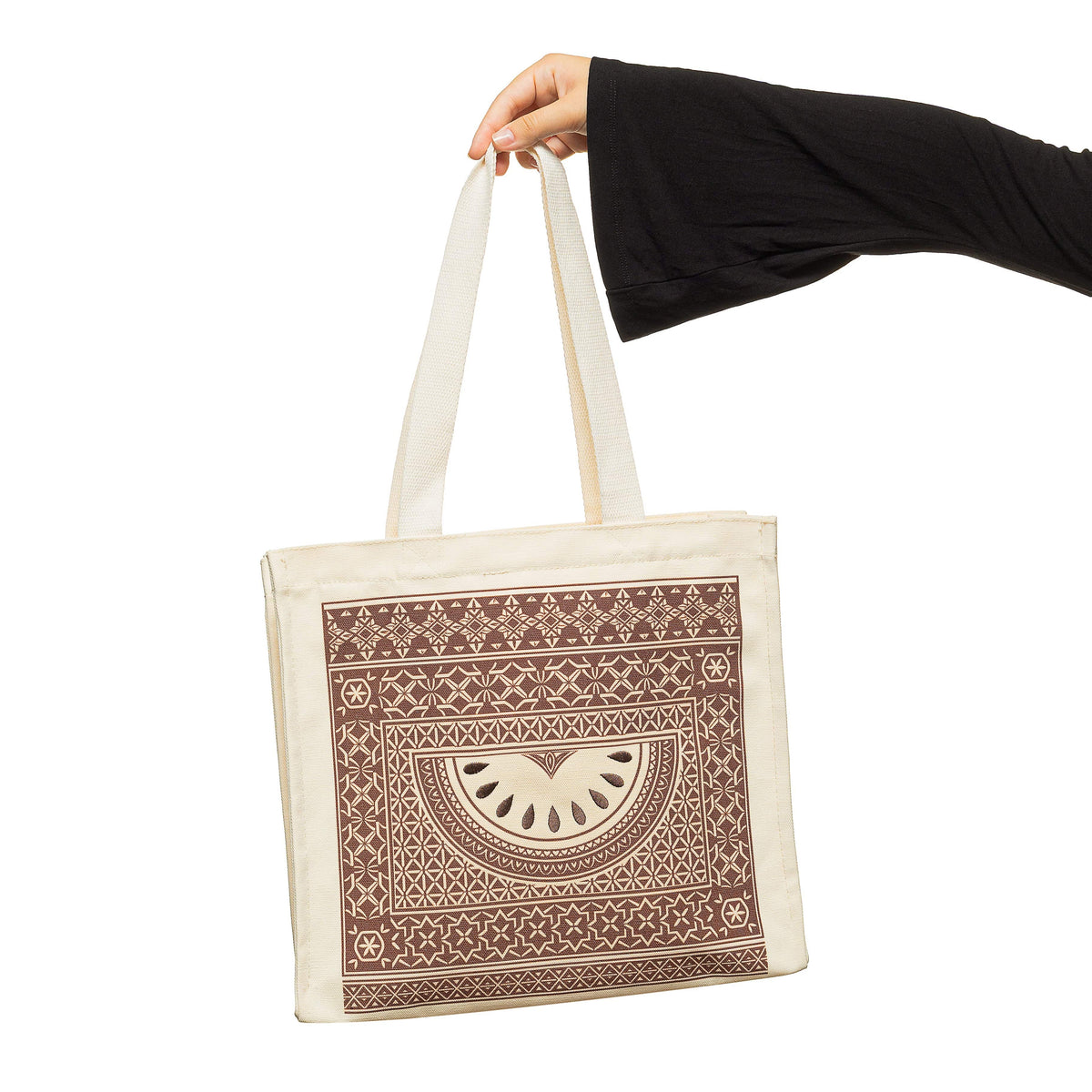 Photo of the Damascus Mosaic Watermelon Tote bag hanging as the model holds it by its strap.