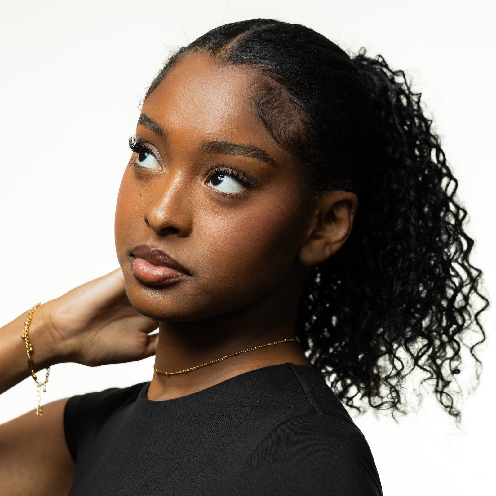 Photo of the model looking up, away from the camera. The model is wearing the Dotted Chain Choker.