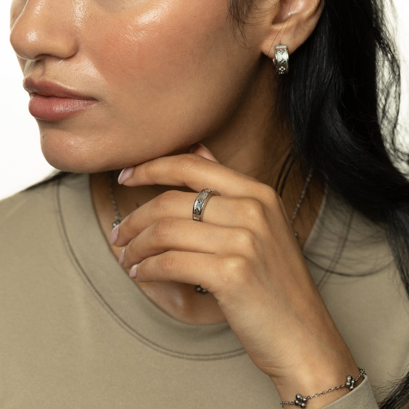 Woman wearing the silver Dotted Henna Ring paired with the Henna Hoops and Dotted Henna Bracelet pimage_ styled with a neutral top.
