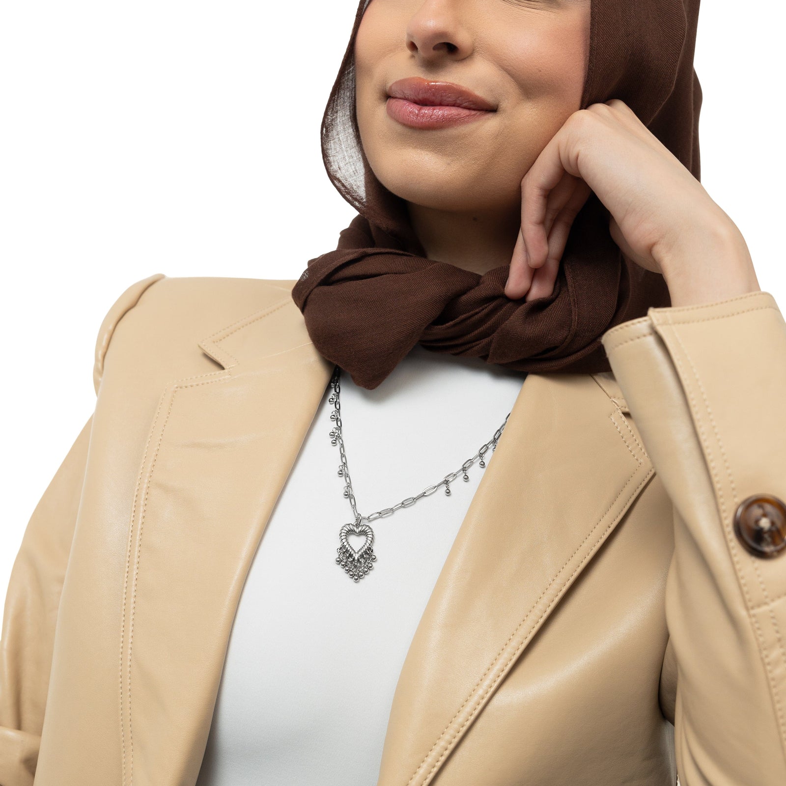 A model showcasing the silver Dotted Heartthrob Necklace, with the pendant hanging gracefully, emphasizing the detailed craftsmanship.