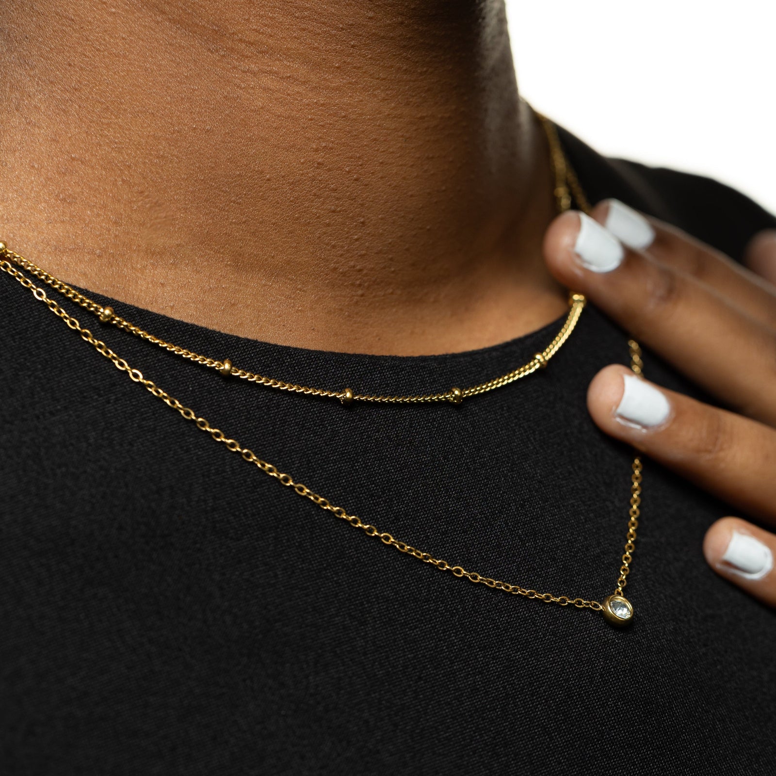 The gold Dotted & Bezel Layering as worn by the model.