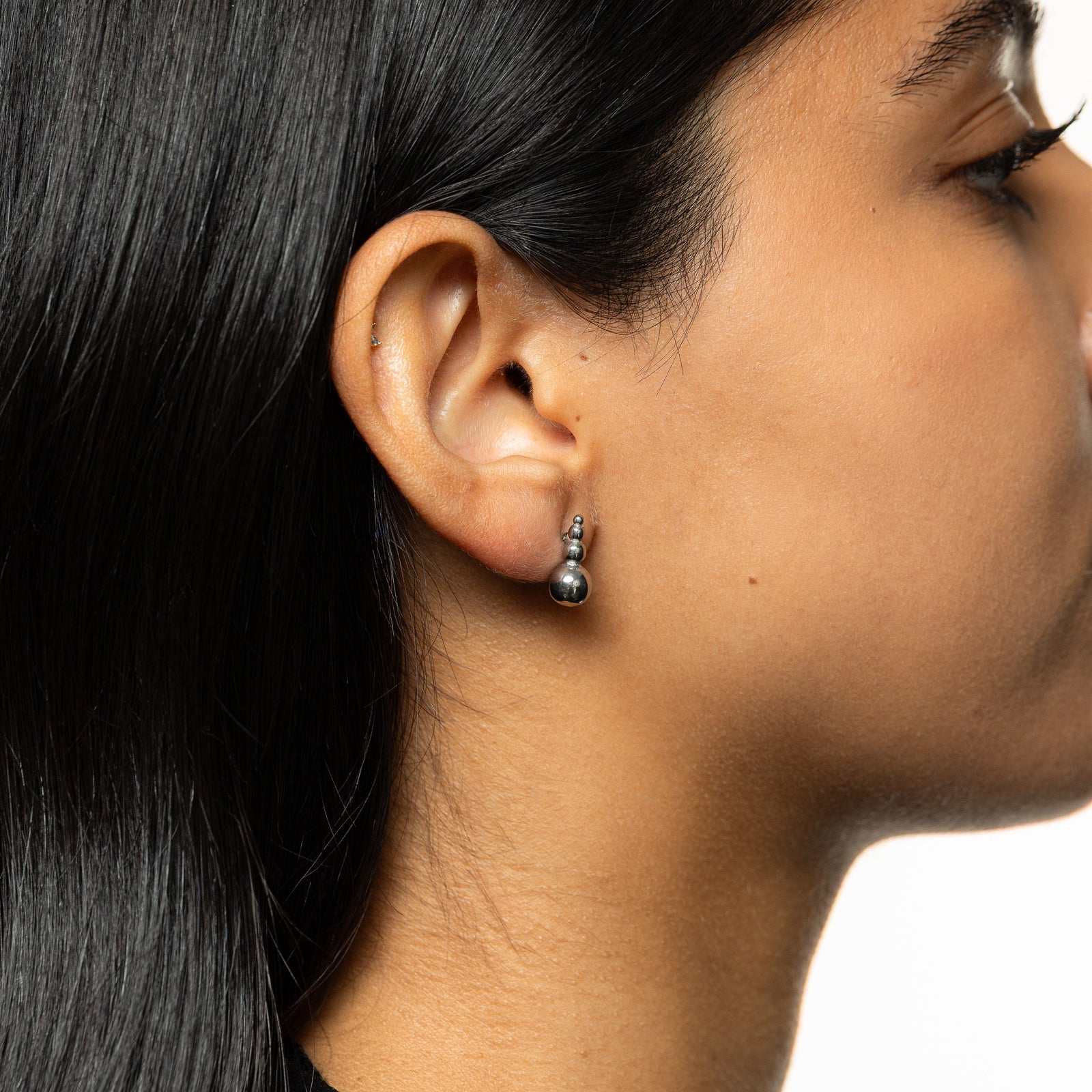 Close-up of the Dotted Studs in silver, featuring three small stacked beads with a larger bead at the base.