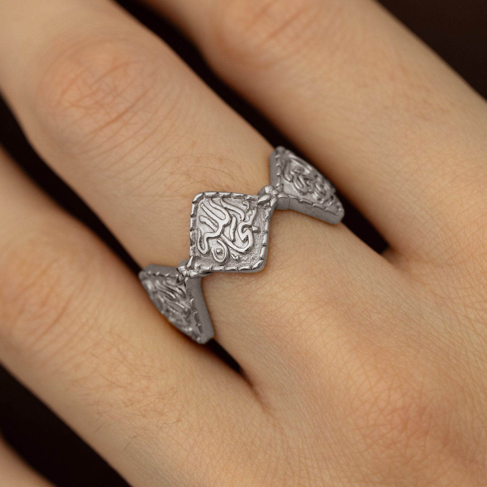 Close up photo of the silver Dotted Thikr Ring as worn by a model.