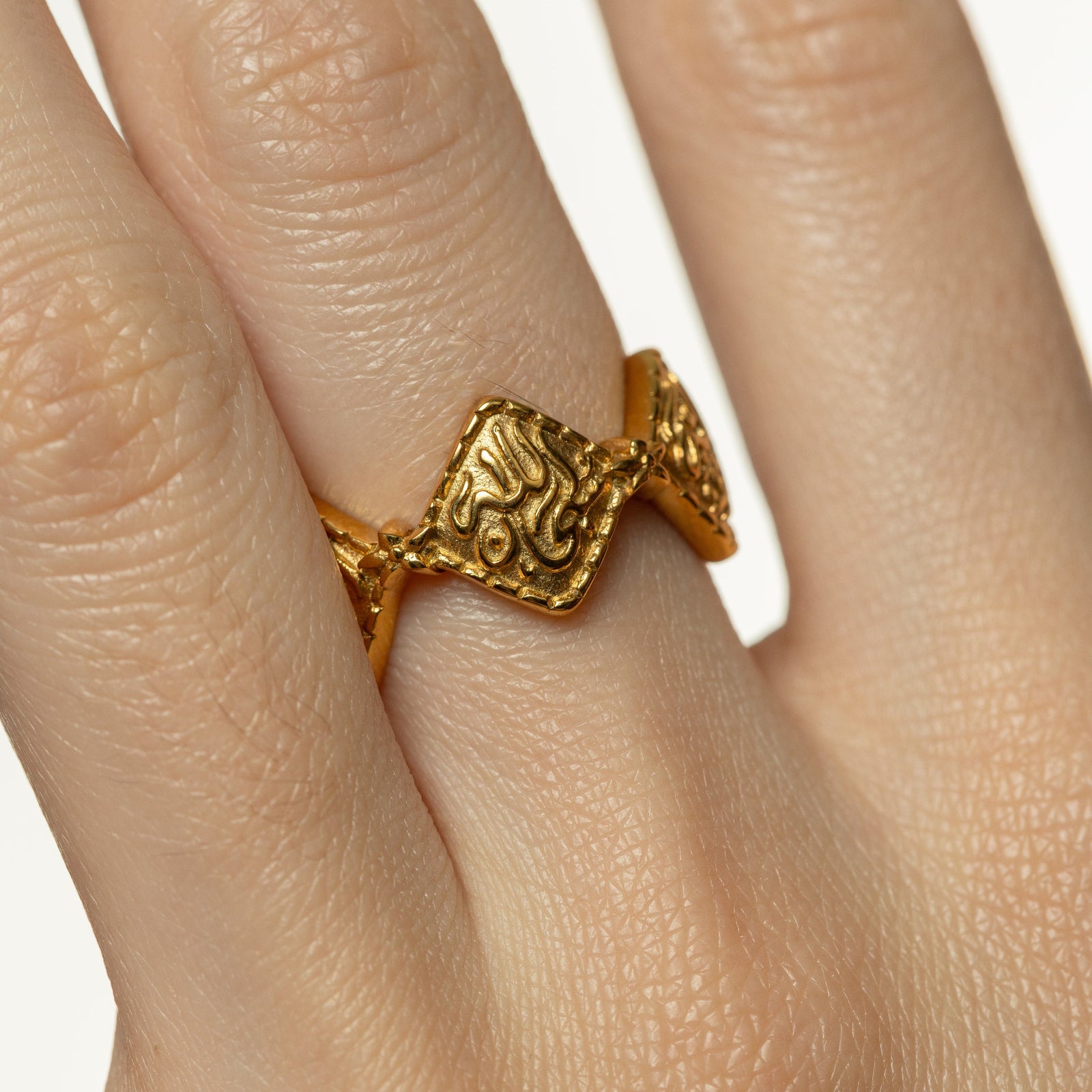 Close up photo of the Dotted Thikr Ring as worn by a model.