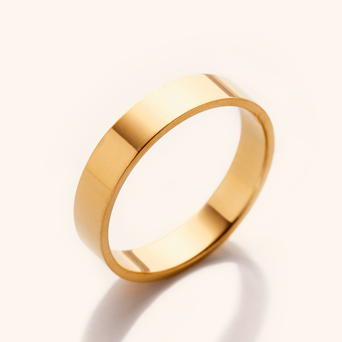 Gold ring with a flat polished surface, displayed on a light background.