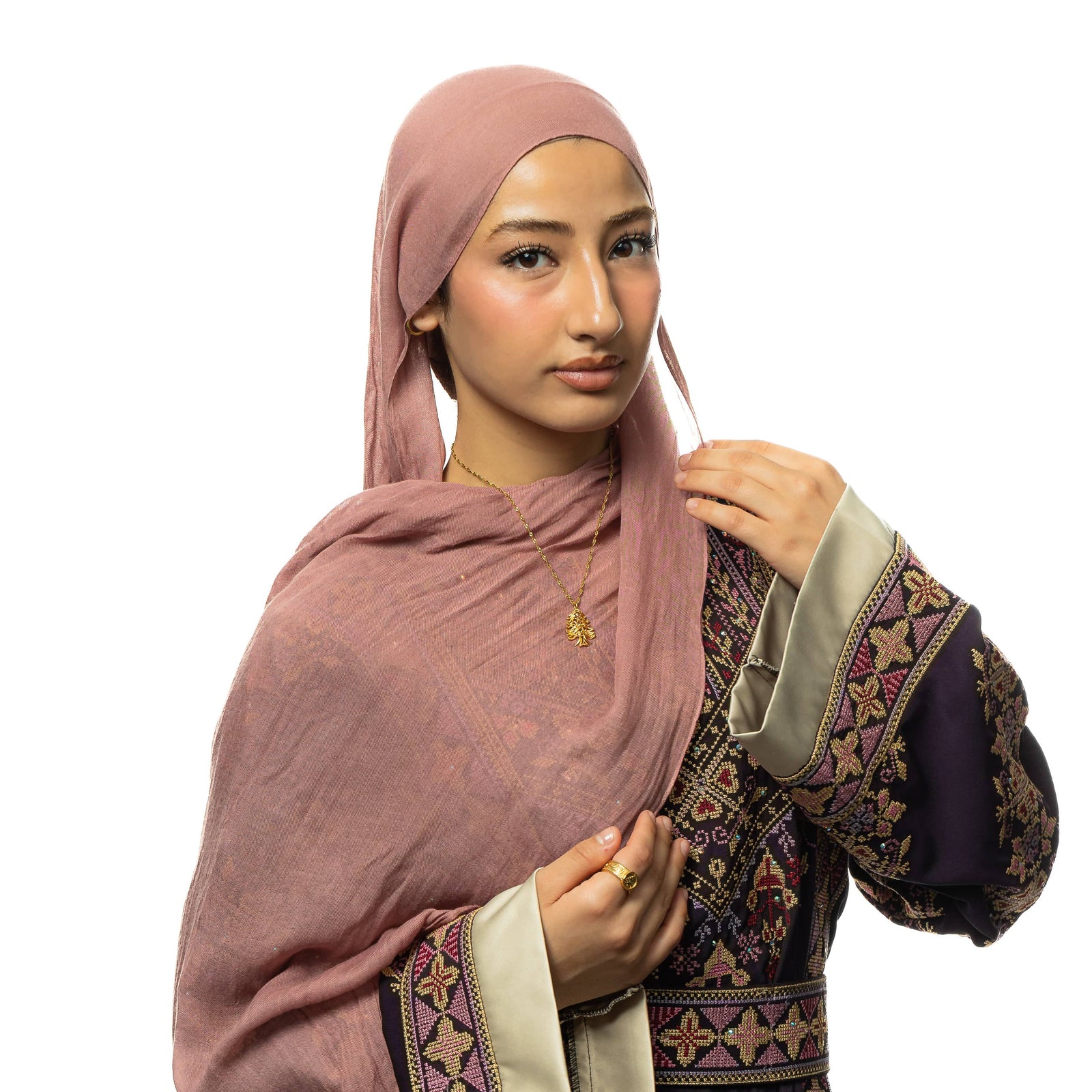 Photo of the model wearing the gold Freedom is the Soul Lebanon Cedar Necklace around their neck and the gold Lebanon Freedom is the Soul ring.