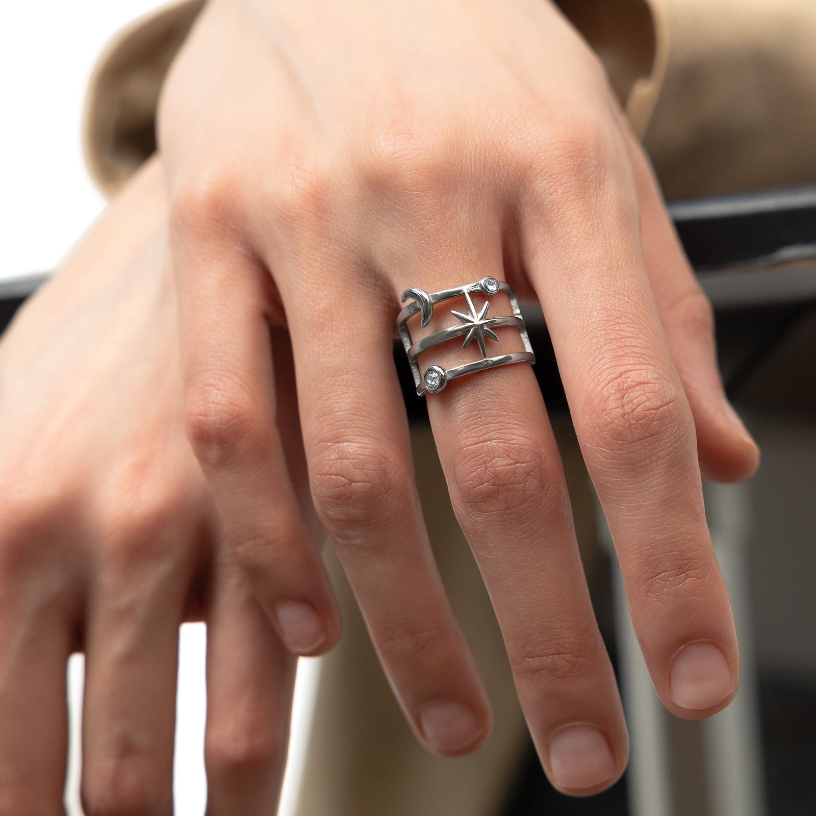 A model showcasing the silver Galaxy Stack Ring on her finger. 