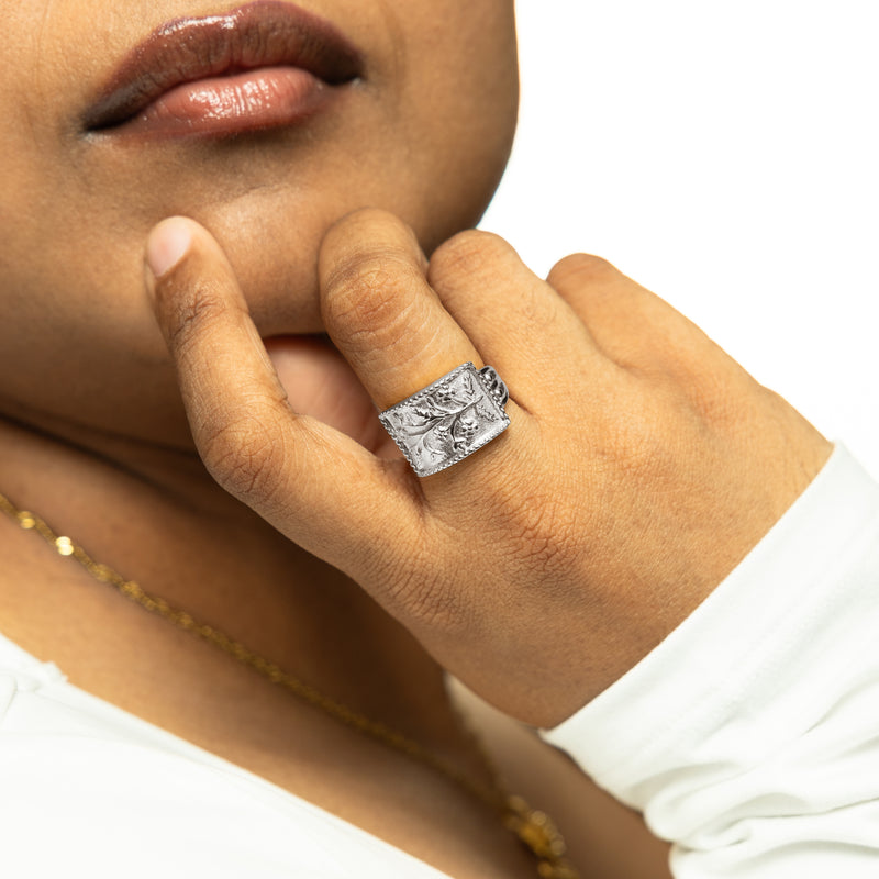 Woman wearing the silver Garden Ring pimage_ hand resting near chin pimage_ styled with a white top and gold necklace.