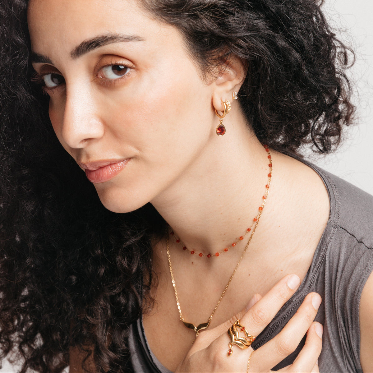 Garnet Set on model: Garnet Stone Keffiyeh Necklace, Garnet Stone Huggie Hoops and Garnet Stone Keffiyeh Droplet Ring
