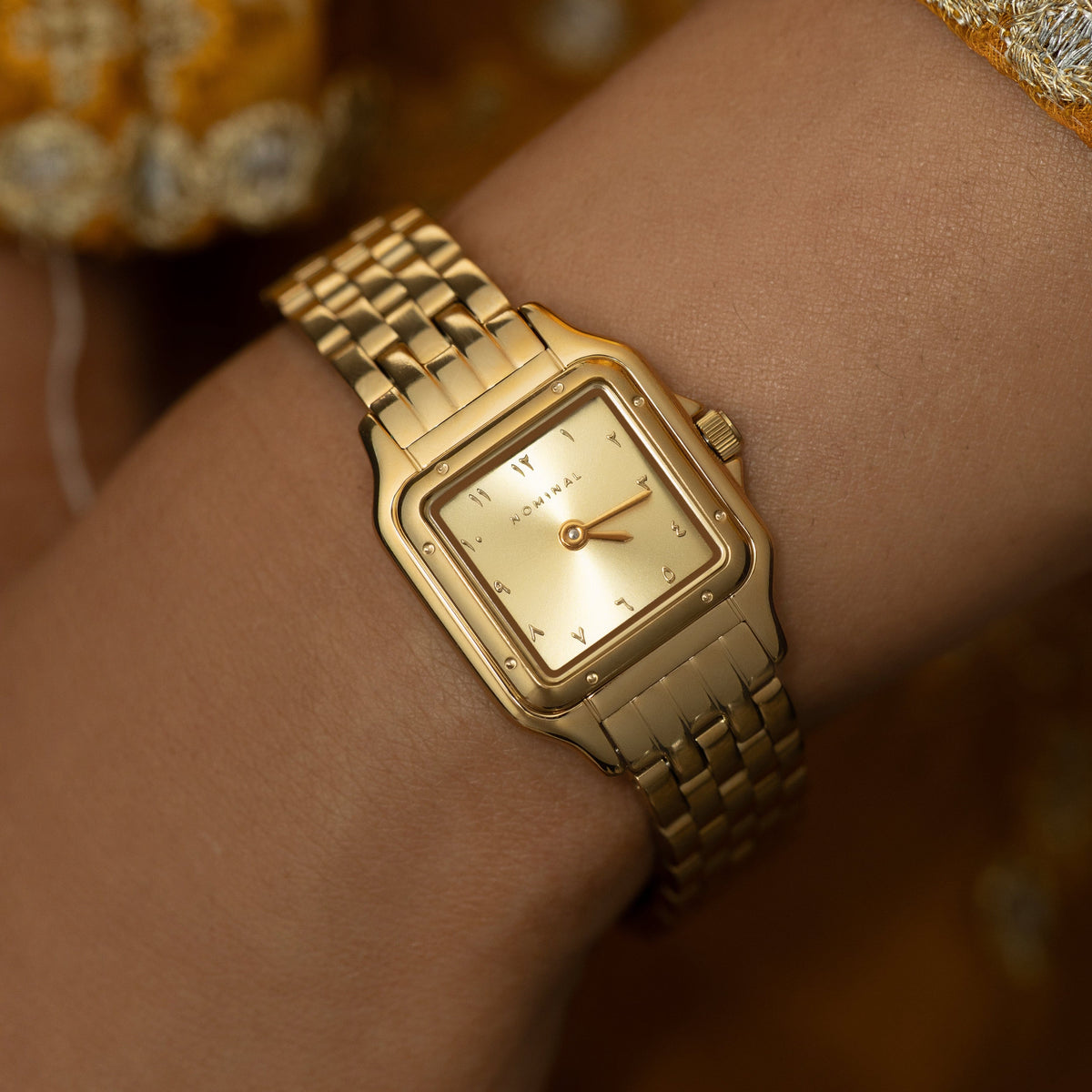 Close up photo of the watch as worn by the model.