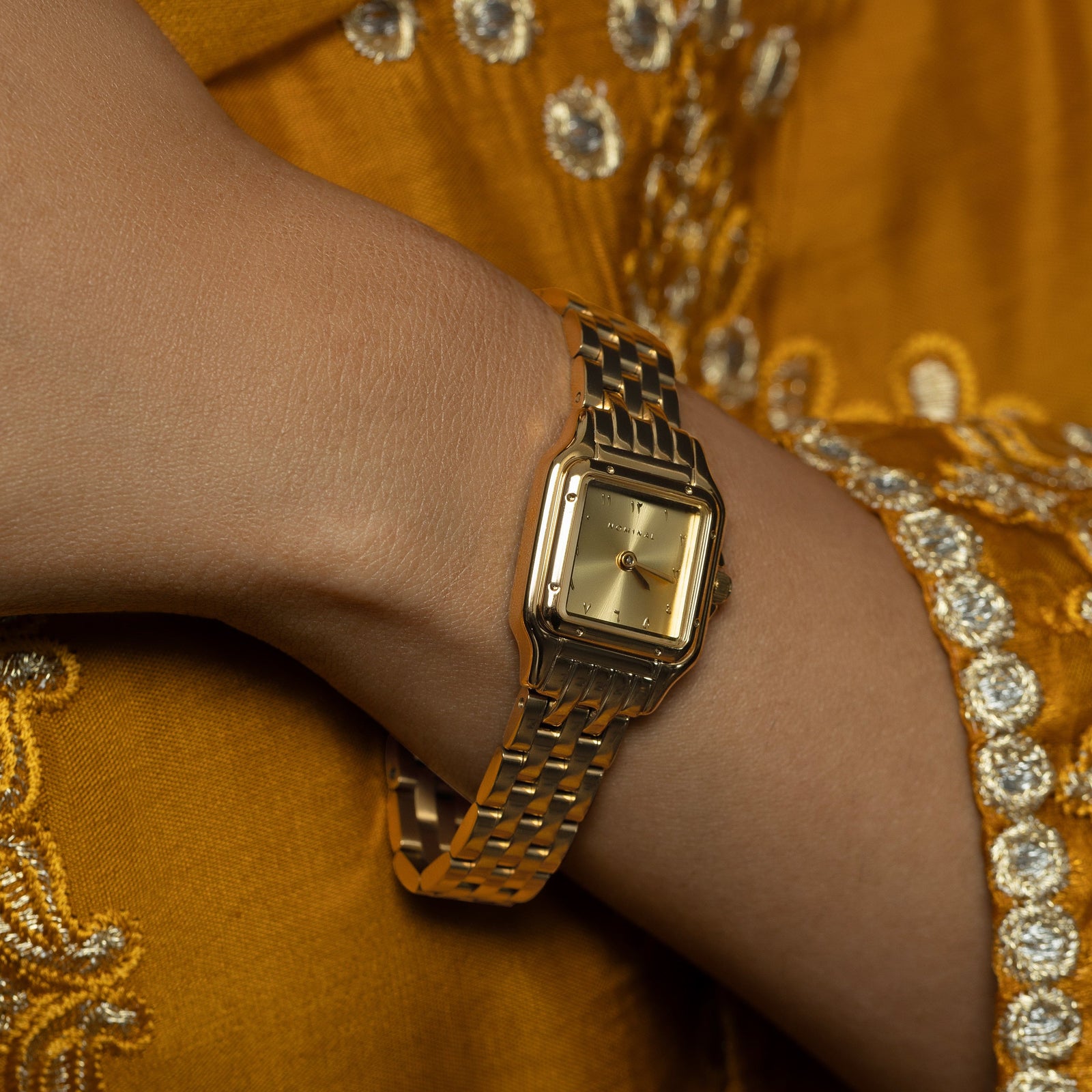 Close up photo of the watch as worn by the model.