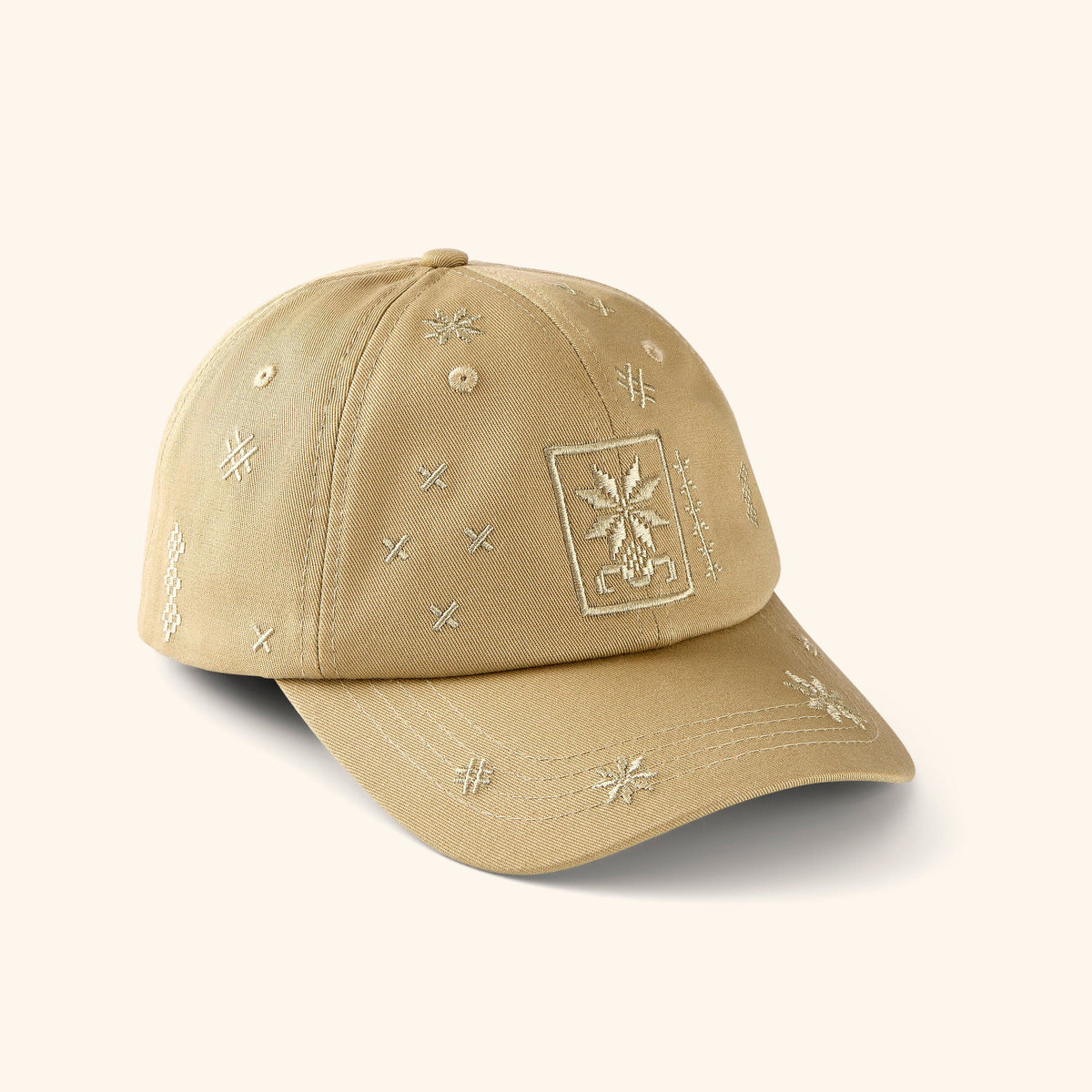 Beige baseball cap with embroidered Tatreez patterns.