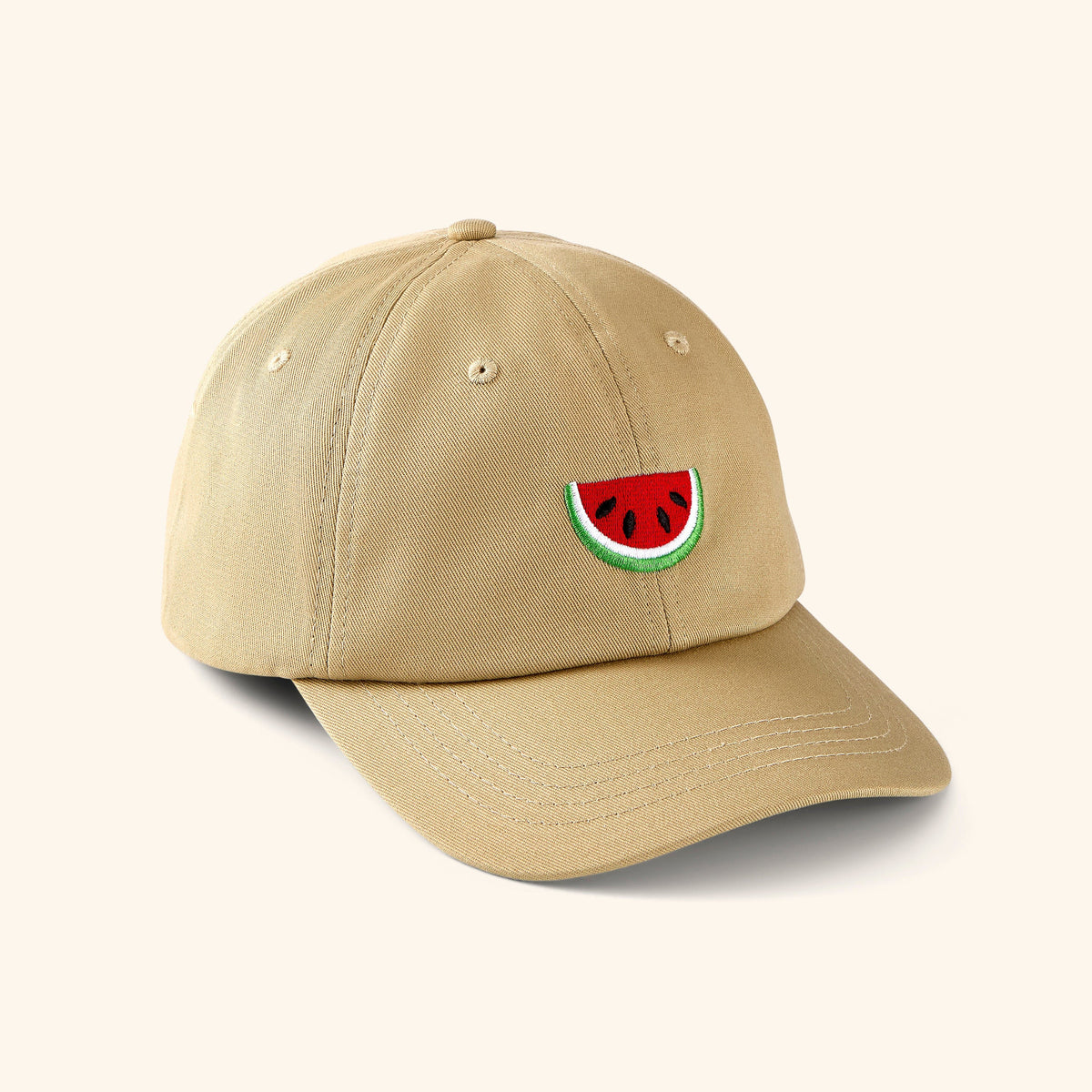 Beige baseball cap with watermelon art featuring the Red, Black, White, and Green colors embroidered in the front center.