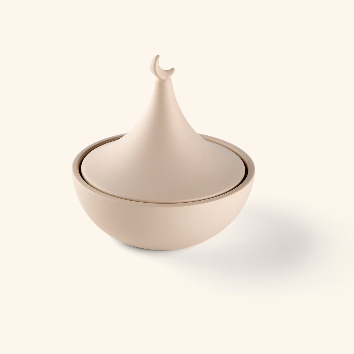 A bowl painted in beige topped with a crescent and star lid, the symbol that's appeared on flags, mosques, and textiles across the Muslim world for centuries.