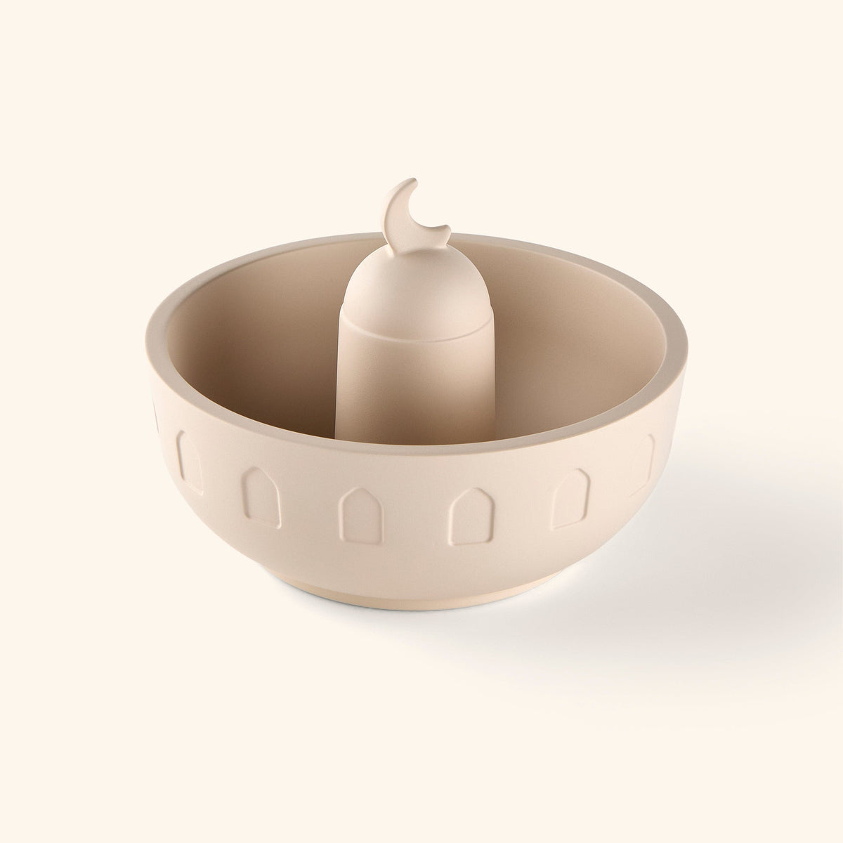 A wide bowl carved with arches around the base and topped with a crescent lid painted in beige.